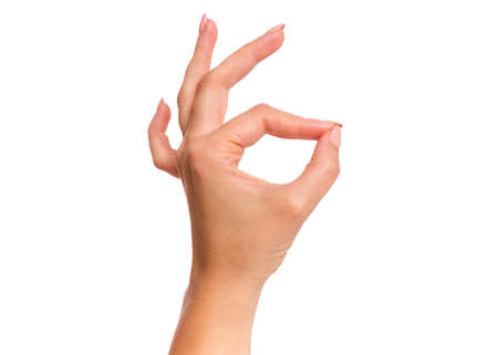 Female hand showing OK gesture, isolated on white background. Beautiful hand of woman with copy space.の写真素材