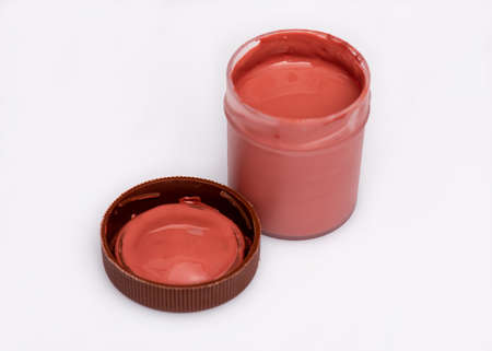 Opened brown Gouache jar, on white background with copy space. Cans of different colors gouache paints.の写真素材
