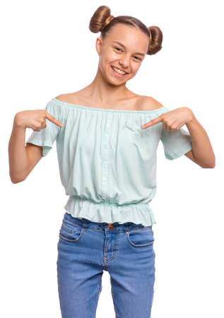 Portrait of teen girl pointing oneself, isolated on white background. Emotions and signs concept. Happy smiling child looking at camera. Young student points fingers at himself.の写真素材