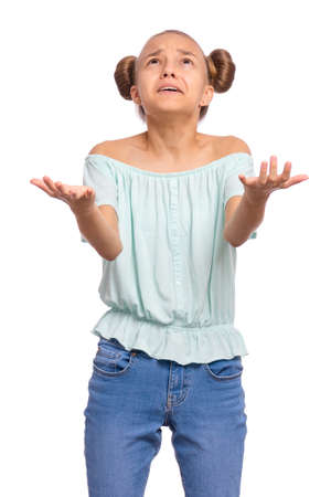 Portrait of teen girl raised hands and trying to catch something. Cute caucasian young teenager looking up, isolated on white background.の写真素材