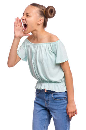 Attention! Portrait of teen girl is holding hand near her open mouth and screaming, isolated on white background. Cute caucasian young teenager shouting with hand cupped to mouth.の写真素材