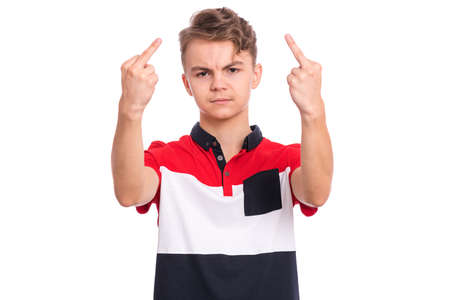 Portrait of angry teen boy showing middle fingers, isolated on white background. Beautiful young teenager showing bad gesture. Upset cute caucasian child doing obscene sign.の写真素材