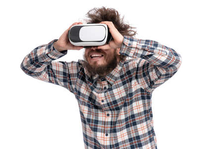 Crazy bearded Man in plaid shirt with funny Haircut wearing virtual reality helmet, isolated on white background. Portrait of funny man using VR goggles.の写真素材