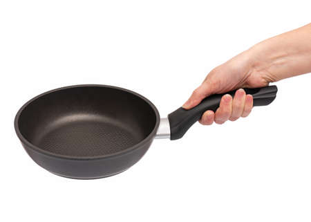 Female hand holding simple new empty Non-stick Frying Pan with black handle, isolated on white background.の写真素材