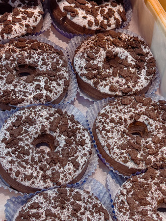 Cake shop with sweets chocolate donuts on showcase table, close-upの写真素材