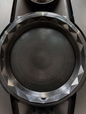 Close-up of musical stereo speaker with protective grill. Modern black audio speaker or music column for background.の写真素材