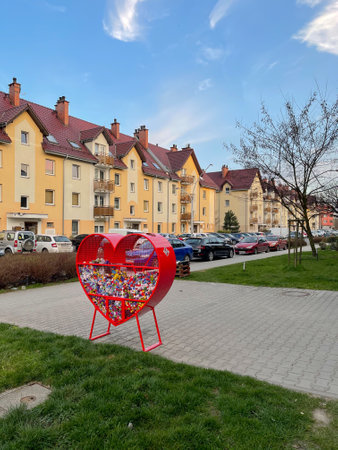 Wroclaw, Poland March 31, 2021: Place for collecting colorful plastic bottle caps for recycling and charity. Heart shaped metal container.のeditorial素材