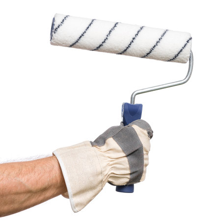 Handyman with work glove holding a paint tool. Male hand wearing working glove with paint roller isolated on white background.の写真素材