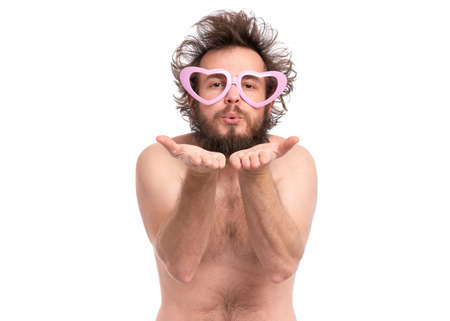 Happy Valentines Day. Bearded Man in heart shaped eye Glasses. Happy and silly guy in Love, isolated on white. Naked man sending air kiss at camera.の写真素材