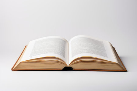 Open old book on white background, top view, unreadable textの素材