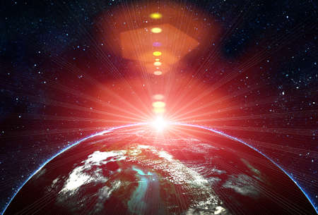 blue earth in space with rising sunの写真素材