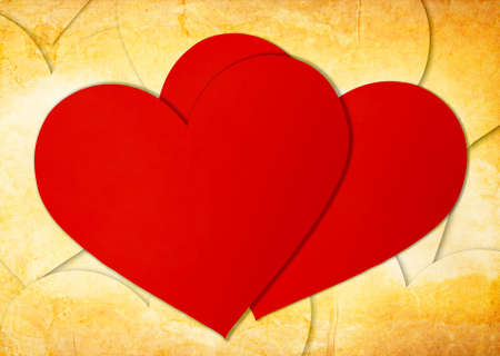 two red paper hearts on grungeの写真素材