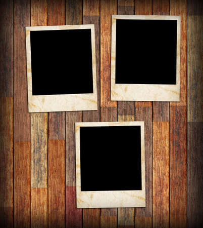 Grunge vintage photo frames on a wood texture backgroundの写真素材