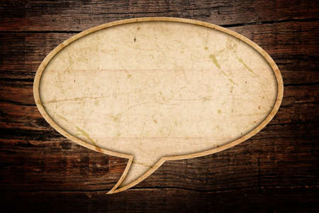 Blank Recycle paper Speech Bubble on wood backgroundの写真素材