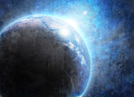 blue earth in space with rising sunの写真素材