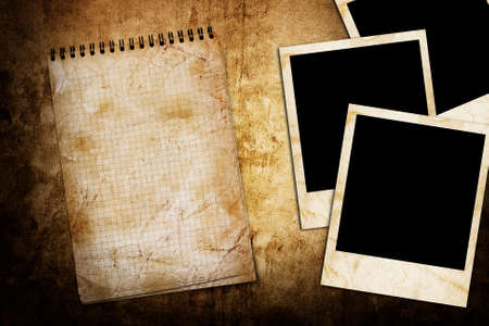 old used notebook on grunge background with photo frameの写真素材