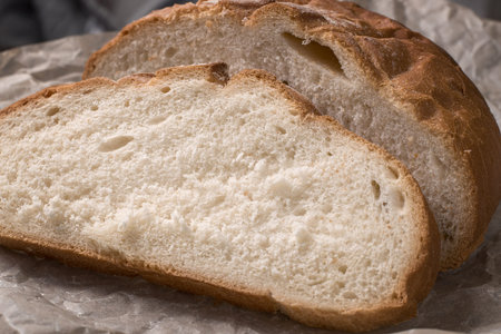 wheat bread is cut into pieces close-up on paper