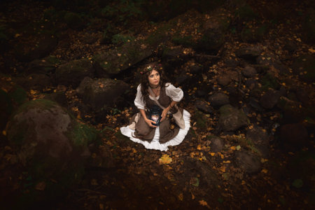 a young witch in an autumn forest