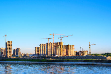 Lots of tower Construction site with cranes and building with blue sky backgroundのeditorial素材