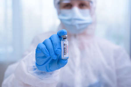 Doctor, nurse, scientist hand in blue gloves holding flu, measles, coronavirus, covid-19 vaccine disease preparing for child, baby, adult, man and woman vaccination shot, medicine and drug concept.の写真素材