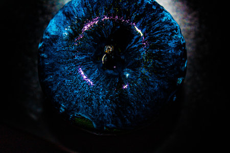 Red apple with dripping blue paint. Minimal food concept.