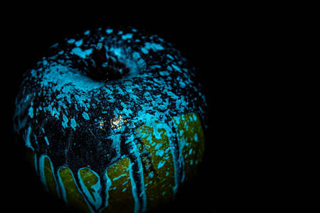 Red apple with dripping blue paint. Minimal food concept.の写真素材
