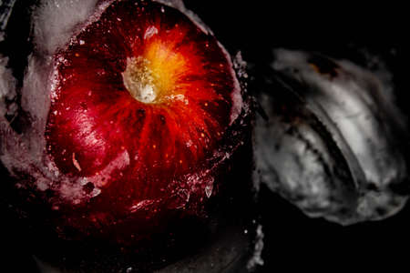 Red apple with dripping blue paint. Minimal food concept.の写真素材