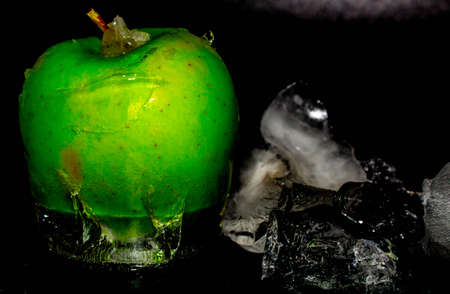 Red apple with dripping blue paint. Minimal food concept.の写真素材