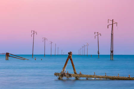 Broken power lines flooded by the sea. Abstract seascapeの写真素材