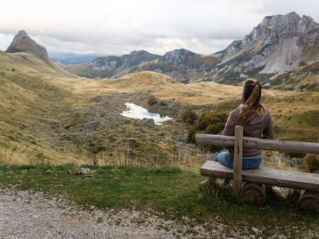 Girl sitting on a bench in the Durmitor National Park. Montenegroの写真素材