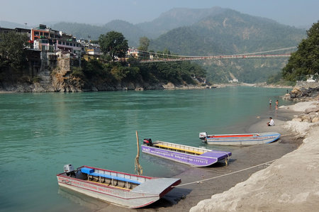 Rishikesh, India - November, 9th, 2017. View of Ganga river embankment and Lakshman Jhula bridge in...