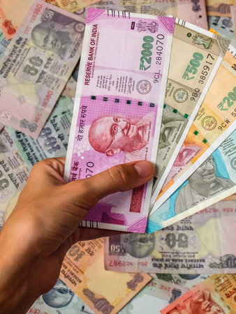 Woman's hands holding indian notes. 10, 20, 50, 100, 200, 500 and 2000 Indian rupees, old and new...