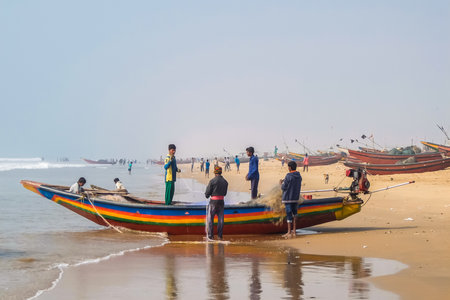 Puri, India - Circa January, 2018. View of fishermen with their boat on the beach in Puri.のeditorial素材
