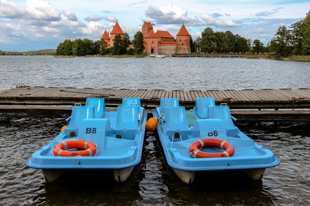 Trakai, Lithuania - Circa August, 2018. Catamarans against backdrop of Trakai castle, lake Galve, Lithuania.のeditorial素材