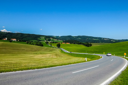 View of road from Koflach (KÃ¶flach) to Piber in bright sunny day.の写真素材