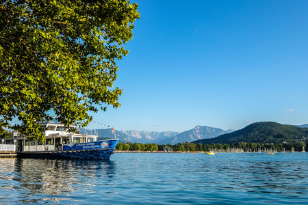 Klagenfurt, Austria - August, 18th, 2017. View of Worth lake with mountains and clear blue sky in background.のeditorial素材
