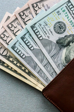Closeup view of wallet with one hundred and fifty dollar banknotes.