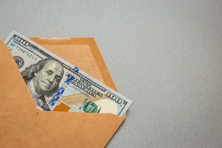 Closeup view of envelope with one hundred dollar banknote.の写真素材