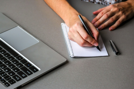 Close up view of business woman making notes.の写真素材