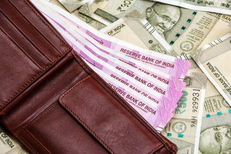 Close up view of leather wallet with brand new indian 2000 rupees banknotes. 500 rupee banknotes in...
