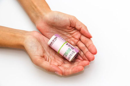 Female hands holding brand new 2000 indian rupees banknotes.