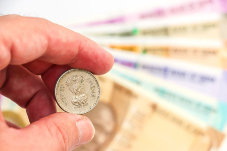 Close up view of Hand holding 5 rupees coin, new indian 10, 50, 100, 200, 500 and 2000 rupees...
