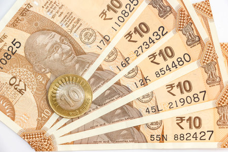 Close up view of brand new indian 10 rupees banknotes and coin.