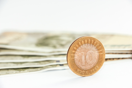 Close up view of brand new indian 500 rupees banknotes and coin on white background.の写真素材
