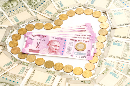 Close up view of new indian 500 and 2000 rupees banknotes and coins. Heartshape concept.の写真素材