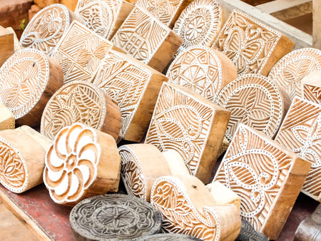 Wooden stamps printing blocks hand carved by artisans on the street market in Jaisalmer, India....