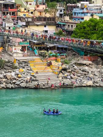 Rishikesh, India - Circa April 2018. Beautiful view of Ganga river embankment in Rishikesh. People...
