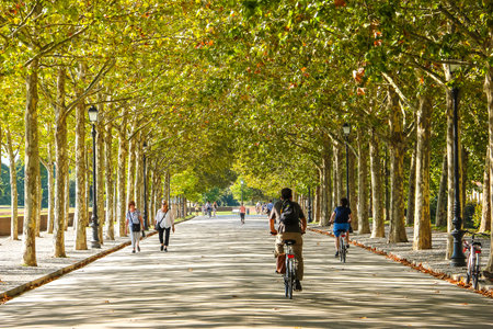 Lucca, Italy - Circa September 2018. People walking, cycling or jogging on the walls around the old city of Lucca (Via delle Mura Urbane).のeditorial素材
