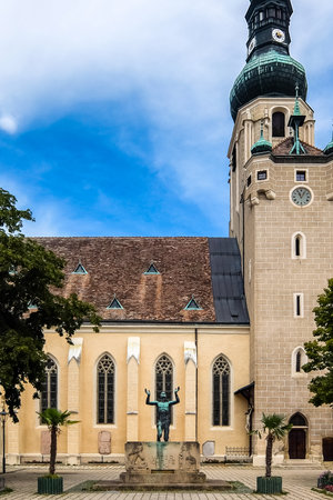 BADEN, AUSTRIA - August 12, 2017. View of St. Stephan Church and statue on Theaterplatz square.のeditorial素材