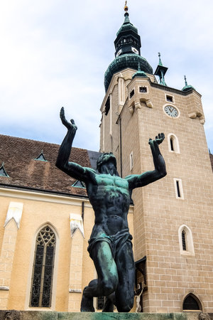 BADEN, AUSTRIA - August 12, 2017. View of St. Stephan Church and statue on Theaterplatz square.のeditorial素材
